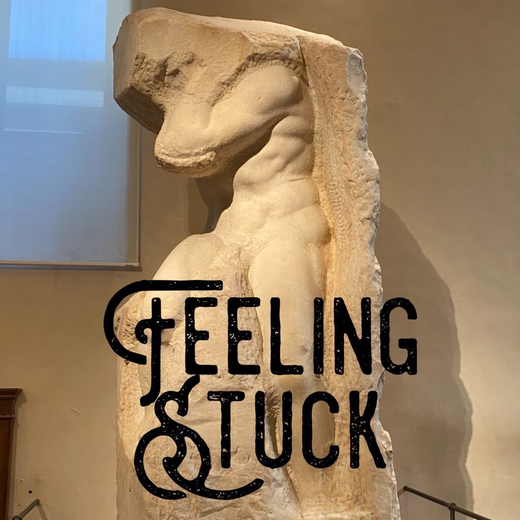 A statue with the words " feeling stuck " written on it.