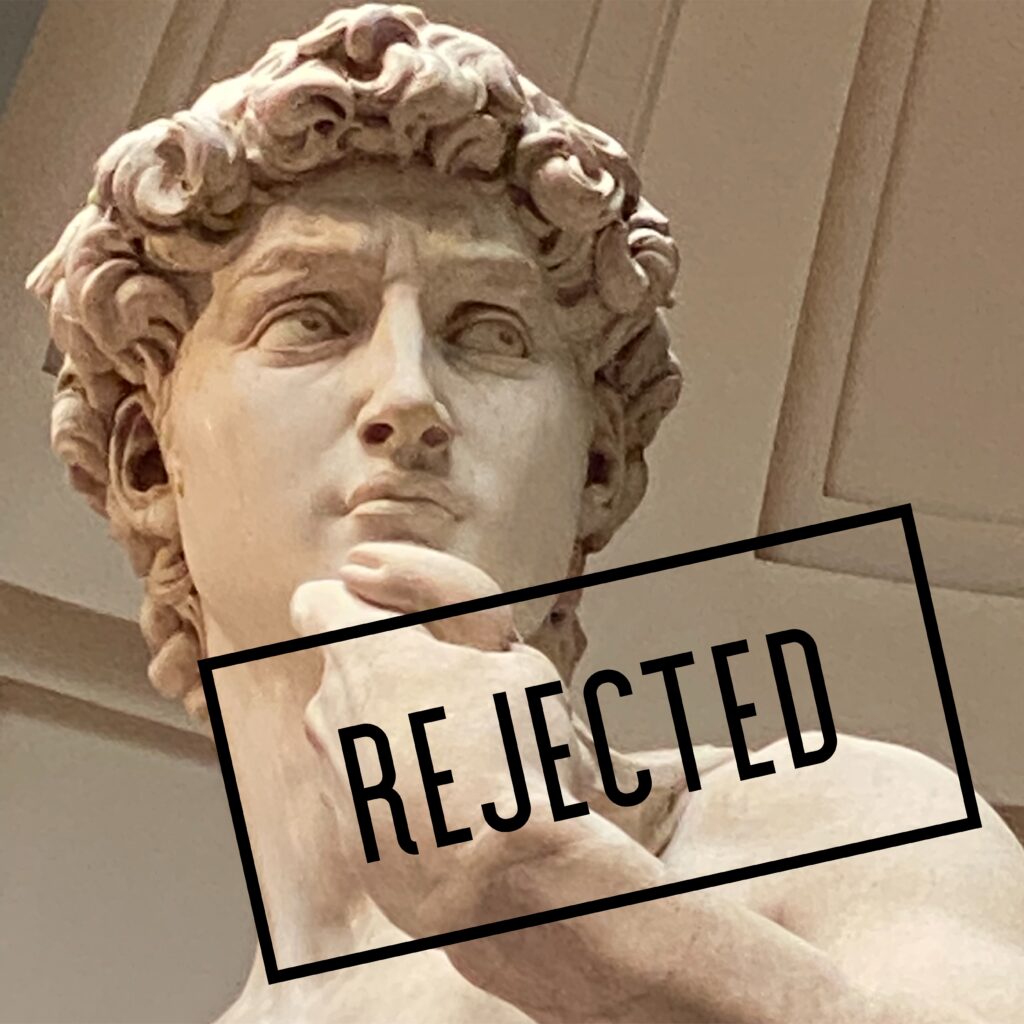 A statue with the word rejected over it.