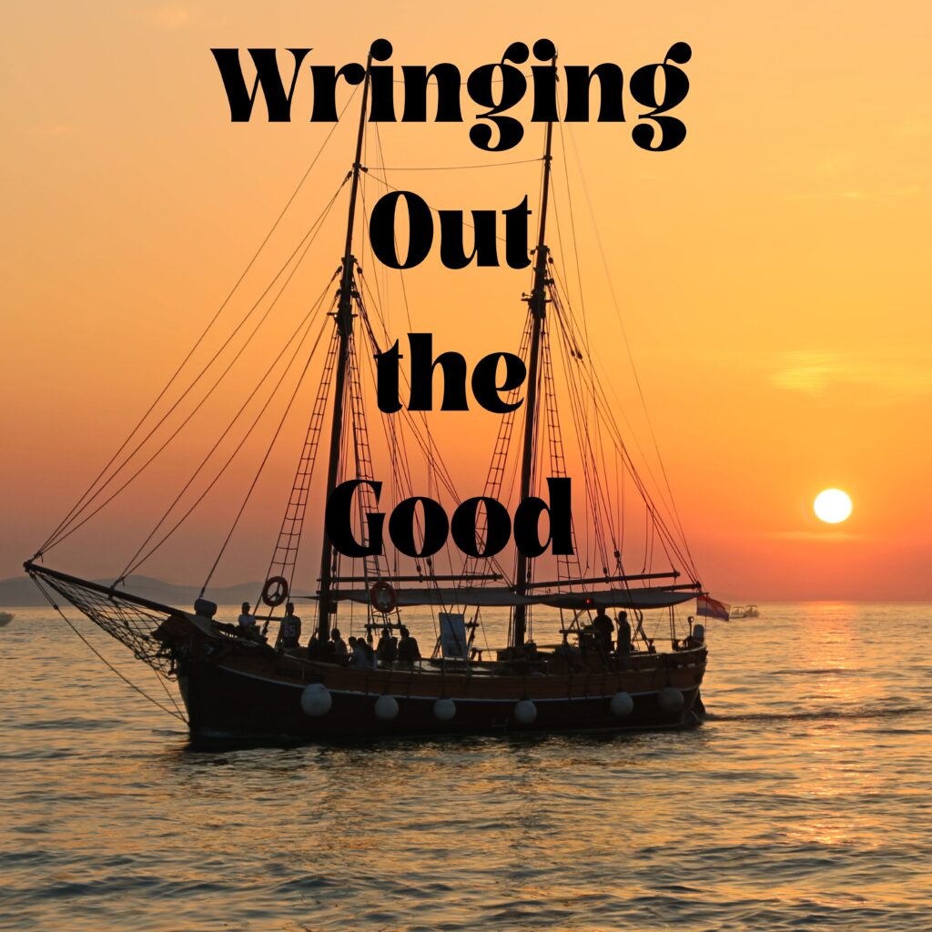 A boat in the ocean with the sun setting behind it.
