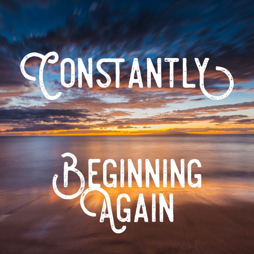 A sunset with the words constantly beginning again