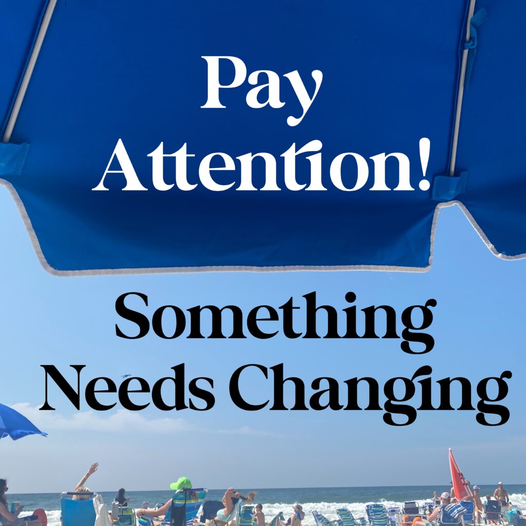 A blue umbrella with people on it and the words " pay attention !"