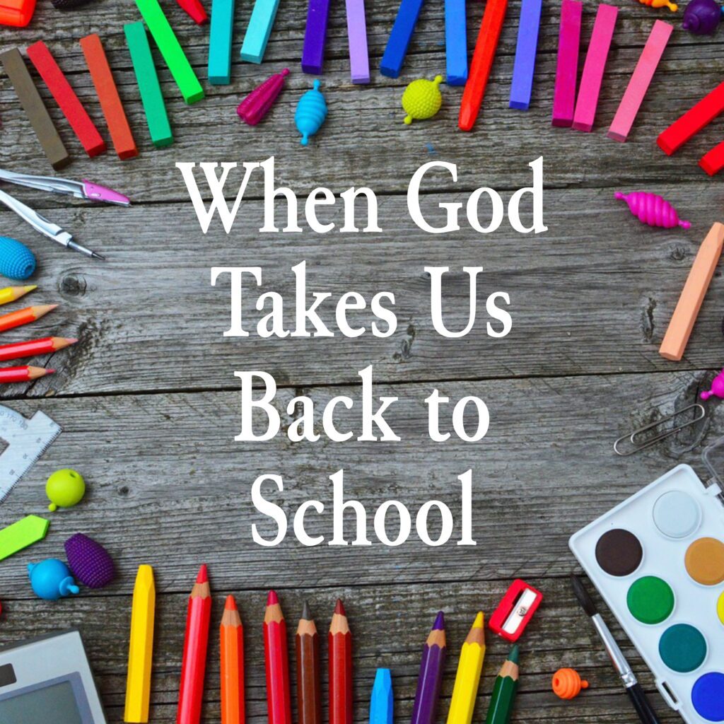 A wooden table topped with lots of school supplies.