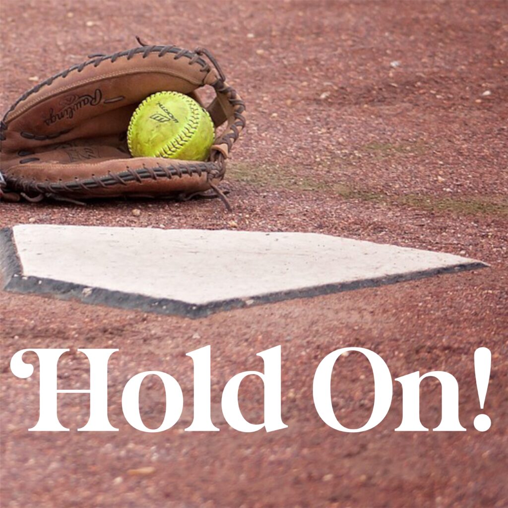 A baseball glove with a ball in it on the ground.