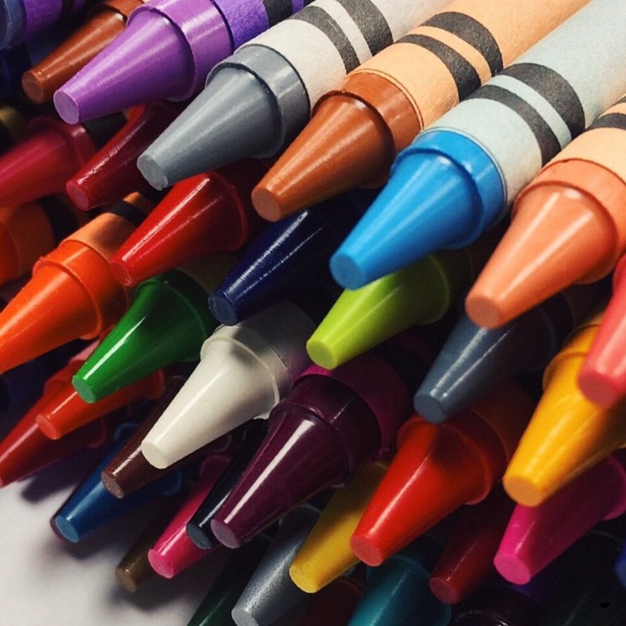 A bunch of crayons are all lined up together